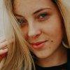 pexels photo 2218786 2218786 Charming close-up portrait of a smiling blonde woman with natural makeup and freckles.
